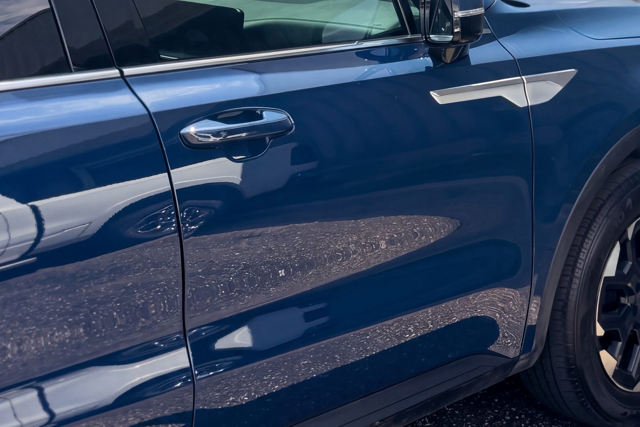 After: the same SUV with the door straight and the mirror replaced